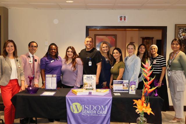 The Wisdom Senior Care team at its table